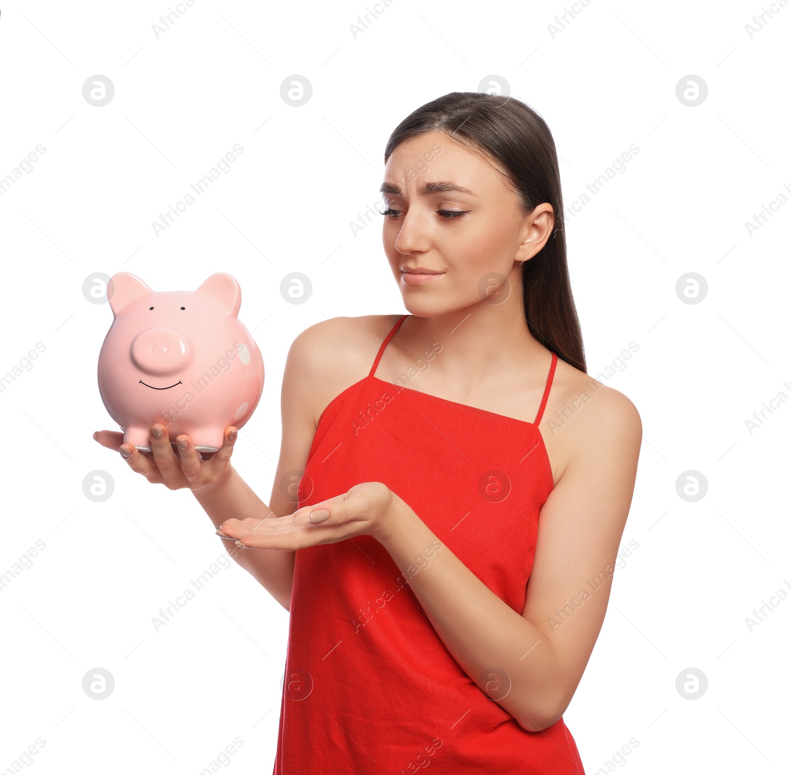 Photo of Sad young woman with piggy bank on white background
