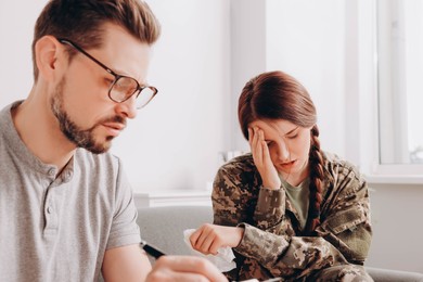 Psychologist working with female military officer in office