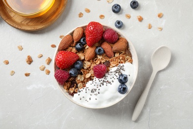 Photo of Tasty homemade granola served on marble table, flat lay. Healthy breakfast