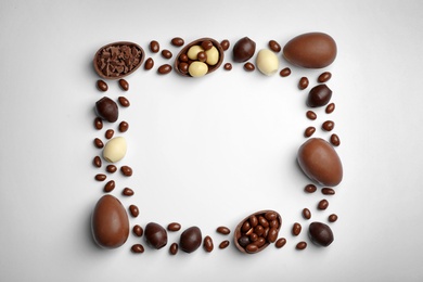 Photo of Flat lay composition with chocolate Easter eggs and space for text on white background