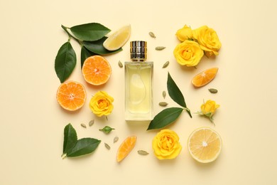 Photo of Flat lay composition with bottle of perfume and fresh citrus fruits on beige background