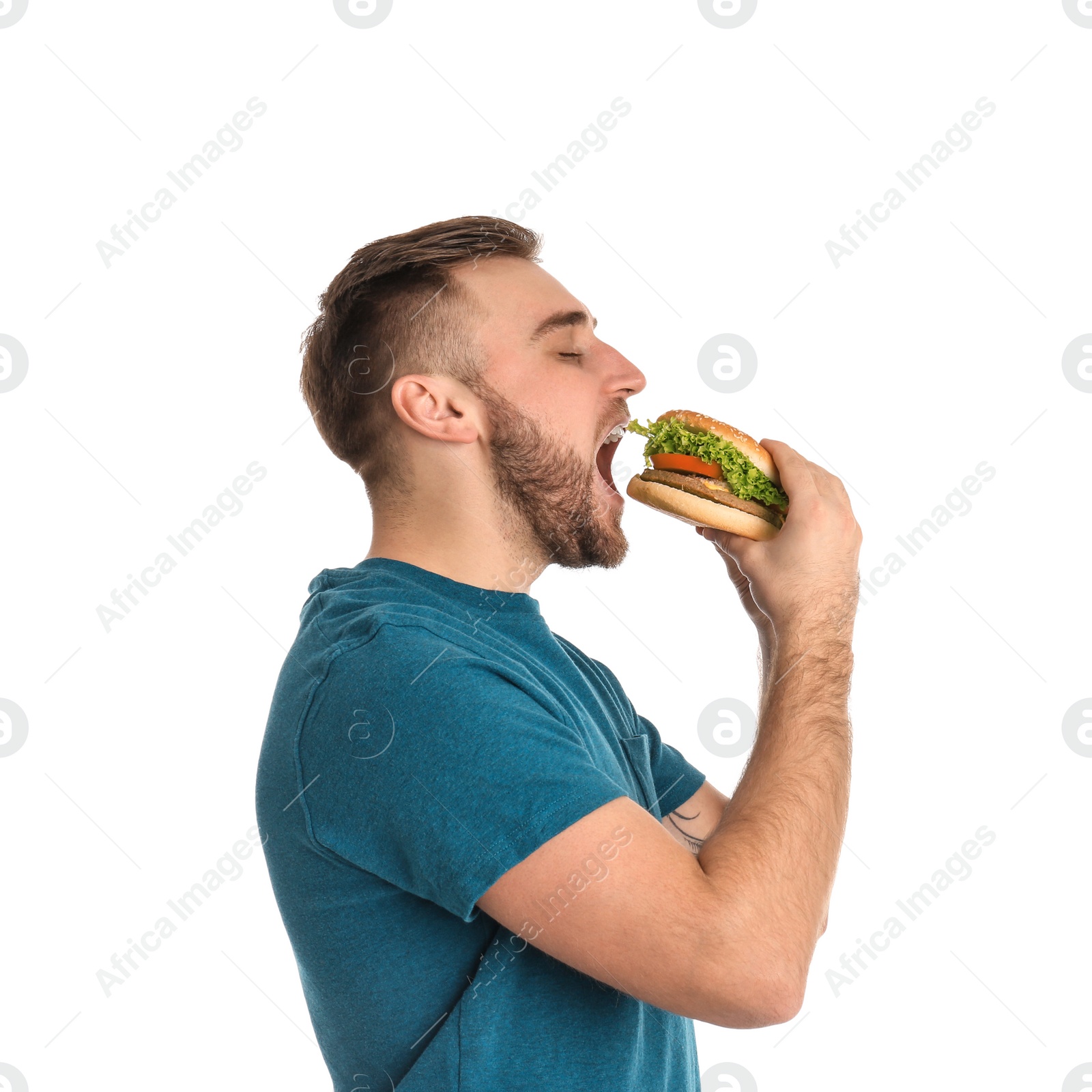 Photo of Young man eating tasty burger on white background