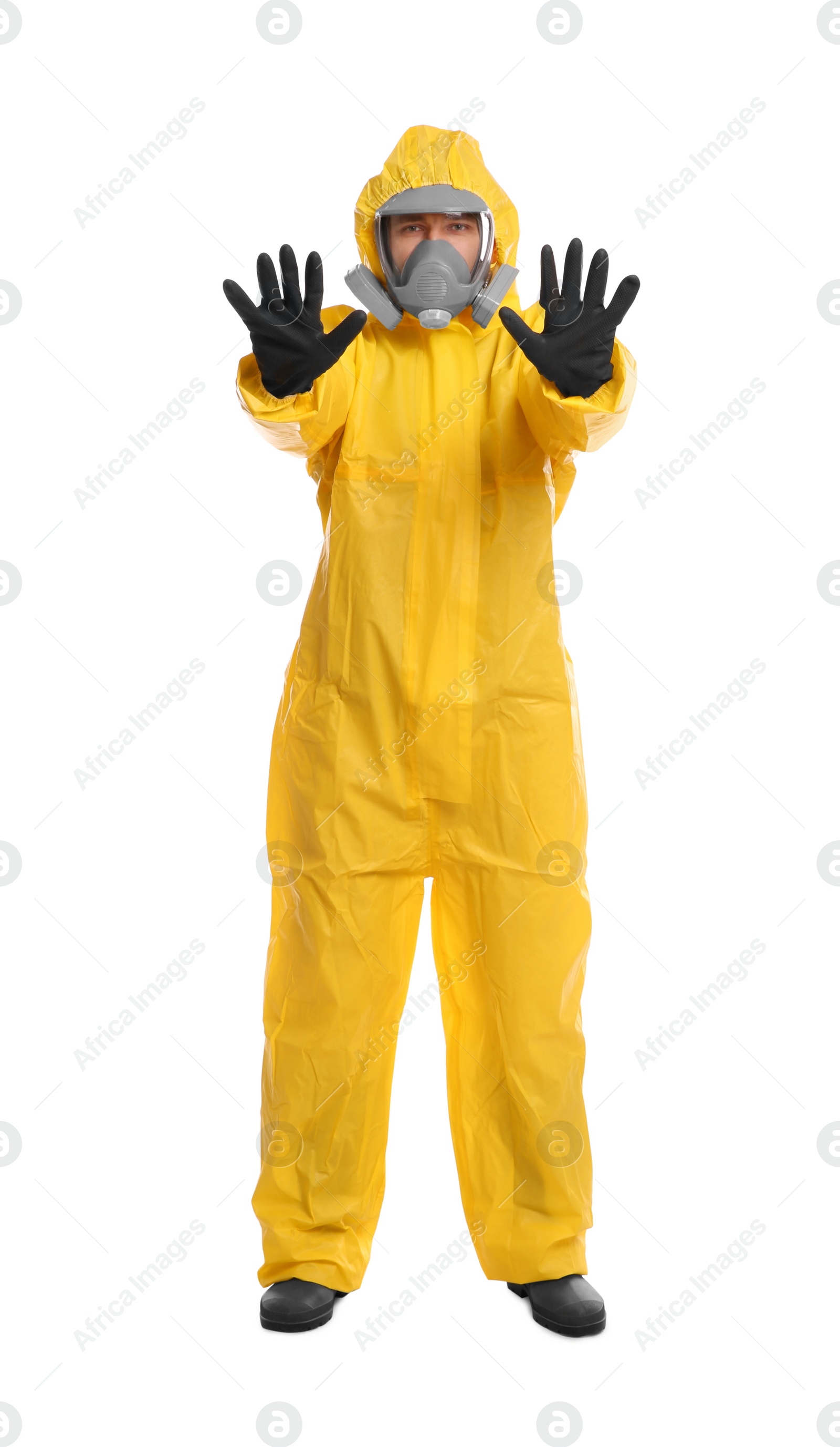 Photo of Man in chemical protective suit making stop gesture on white background. Virus research