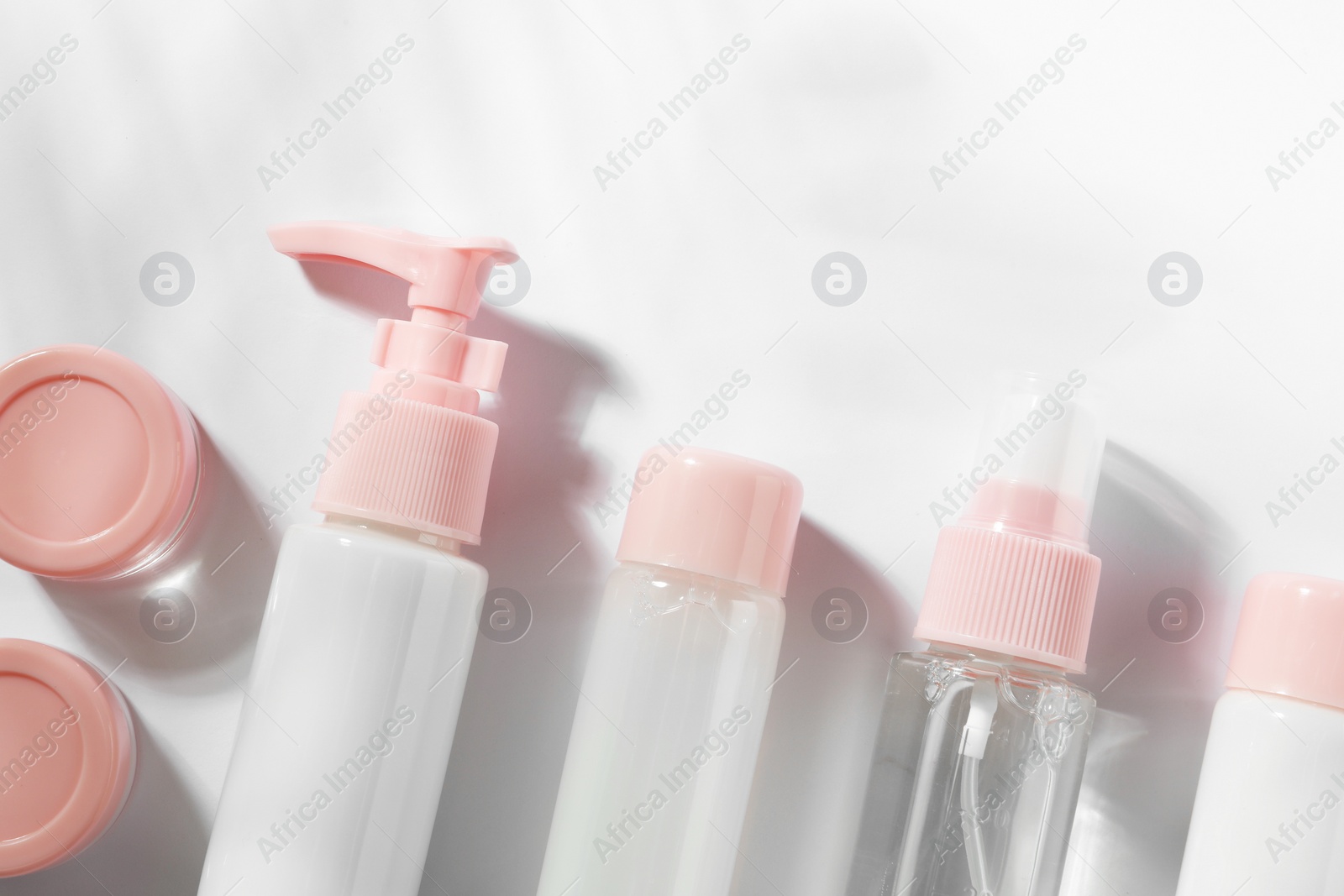 Photo of Cosmetic travel kit on white background, top view