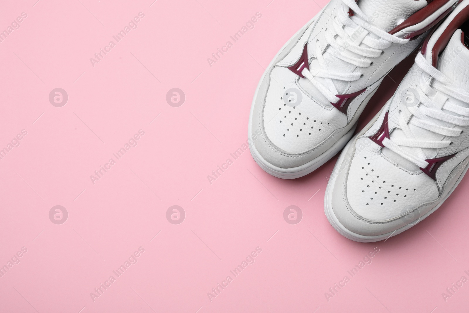 Photo of Pair of stylish shoes on pink background, top view. Space for text