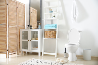 Interior of stylish bathroom with toilet bowl