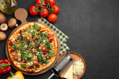 Photo of Delicious vegetarian pizza, ingredients and grater on black table, flat lay. Space for text