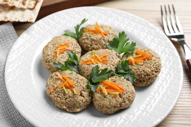 Plate of traditional Passover (Pesach) gefilte fish on wooden background, closeup