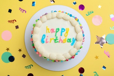 Photo of Cute bento cake with tasty cream and confetti on yellow background, flat lay