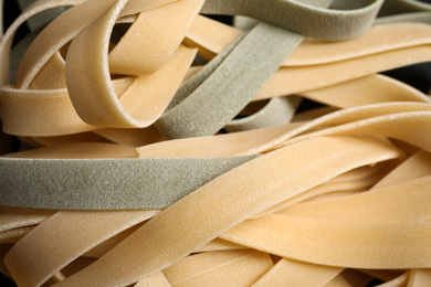 Photo of Closeup view of fresh raw tagliatelle pasta
