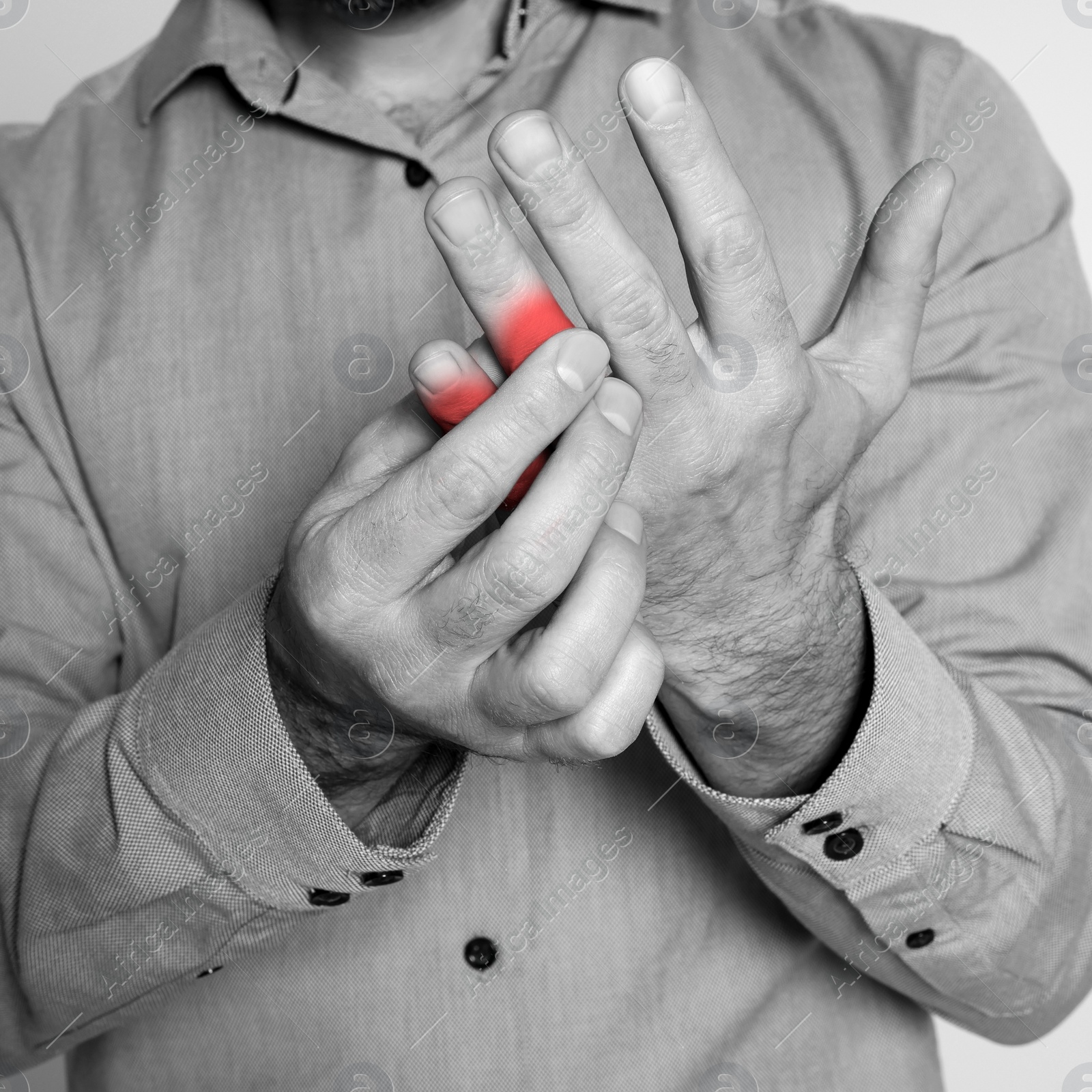 Image of Man suffering from rheumatism, closeup. Black and white effect with red accent in painful area