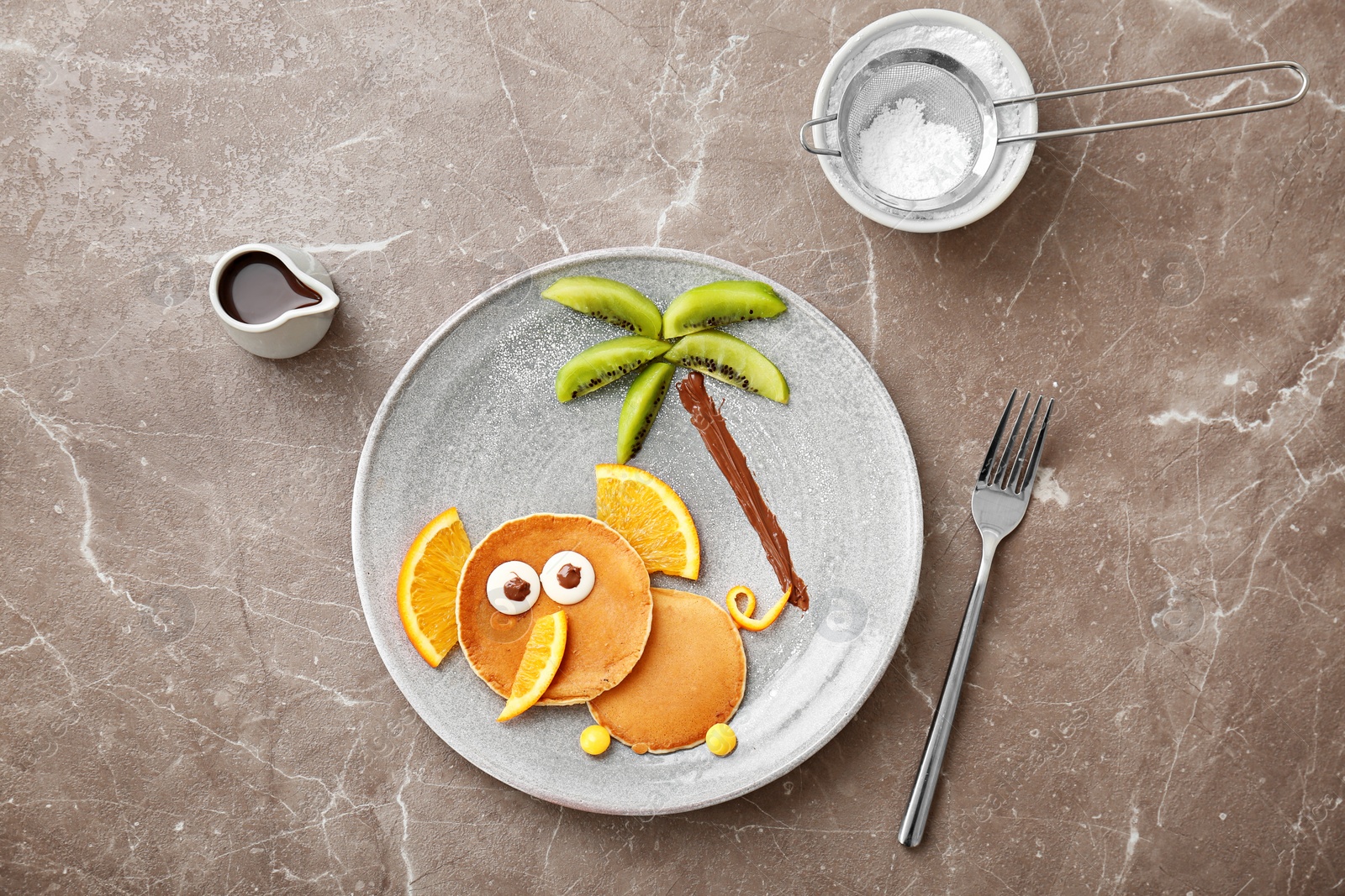 Photo of Flat lay composition with pancakes in form of elephant on grey background. Creative breakfast ideas for kids