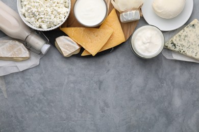 Photo of Different fresh dairy products on grey table, top view. Space for text