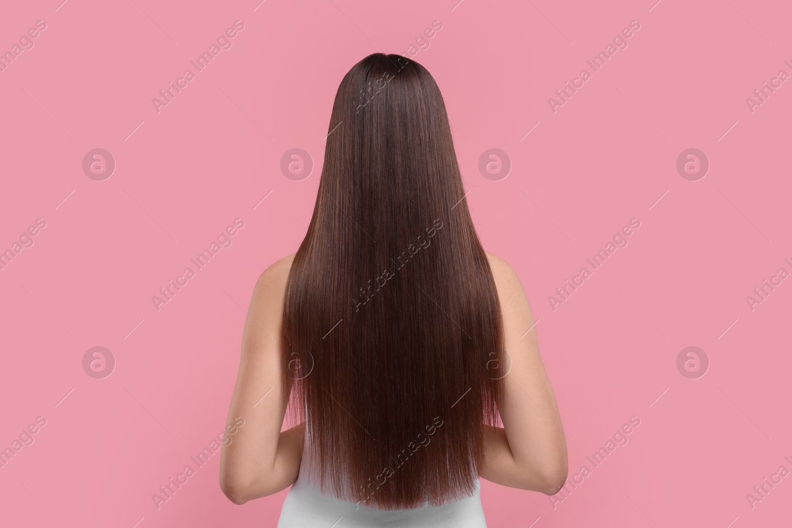 Photo of Woman with smooth healthy hair after treatment on pink background, back view