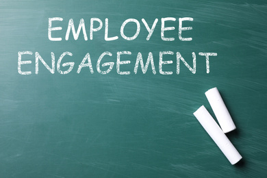 Text Employee Engagement and chalk on greenboard, top view
