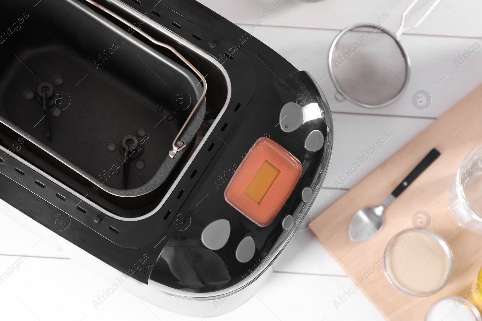 Photo of Breadmaker and different products on white wooden table, flat lay