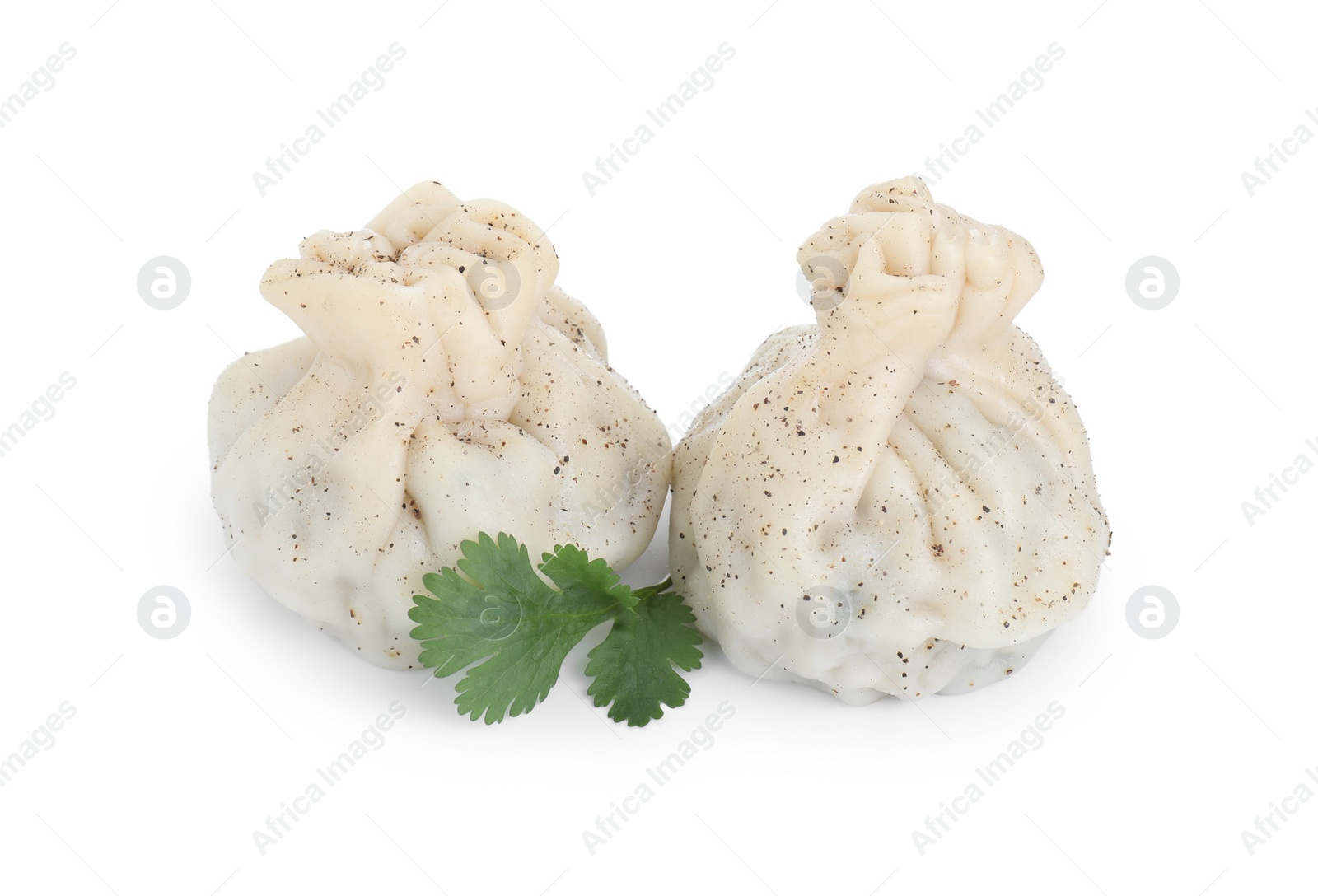 Photo of Two tasty khinkali (dumplings) and spices isolated on white. Georgian cuisine