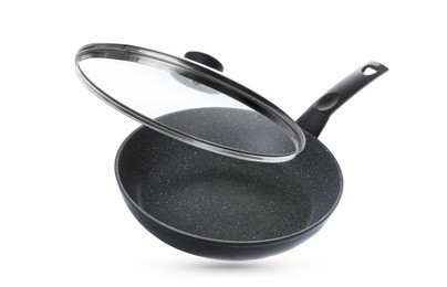 Image of New frying pan and glass lid on white background