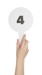 Photo of Woman holding auction paddle with number 4 on white background, closeup