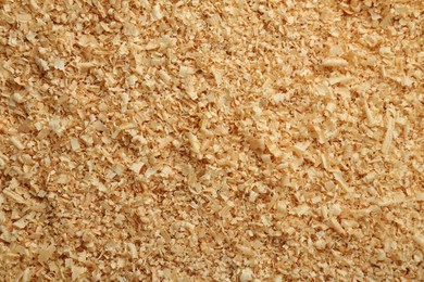 Photo of Dry natural sawdust as background, top view