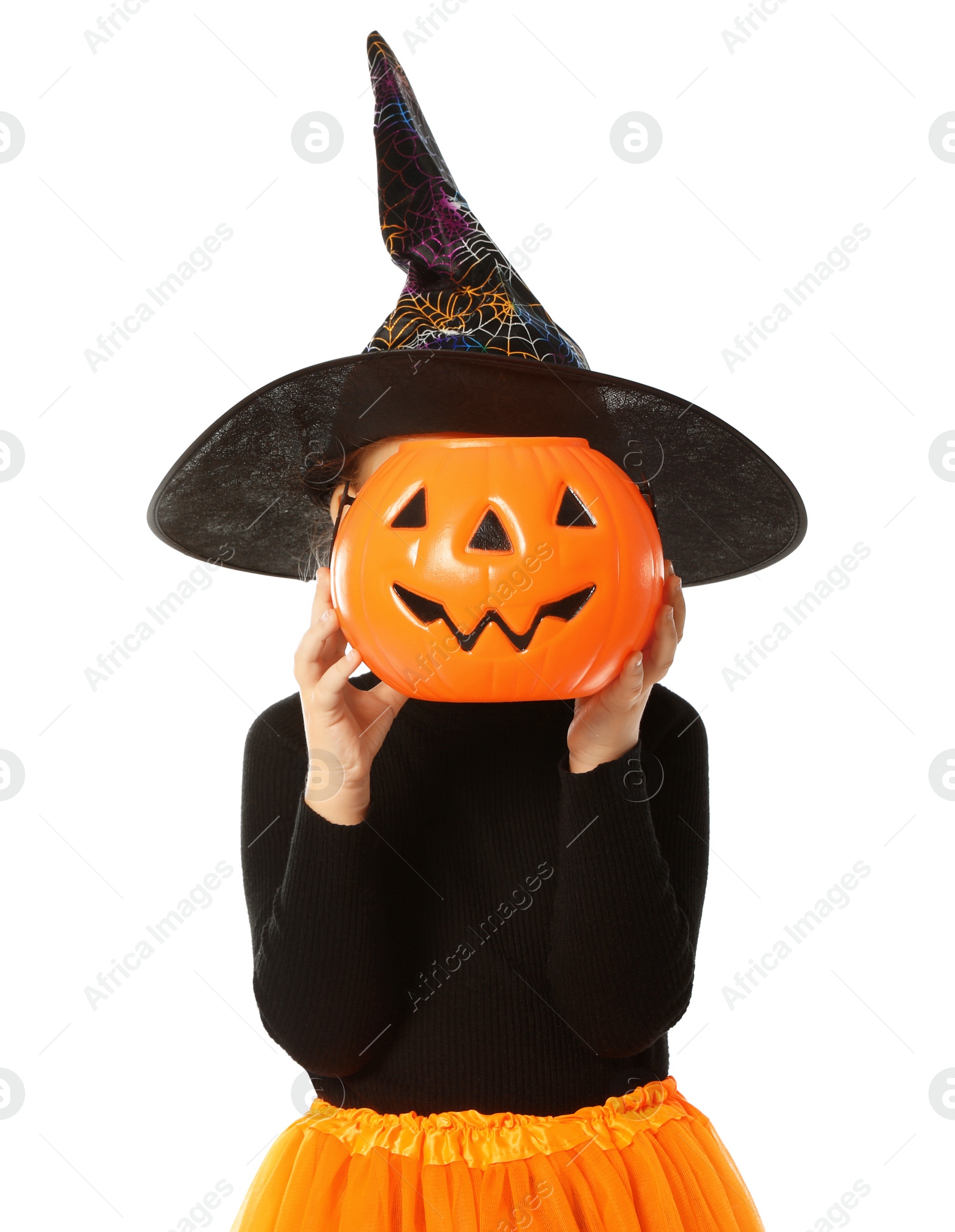 Photo of Cute little girl with pumpkin candy bucket wearing Halloween costume on white background