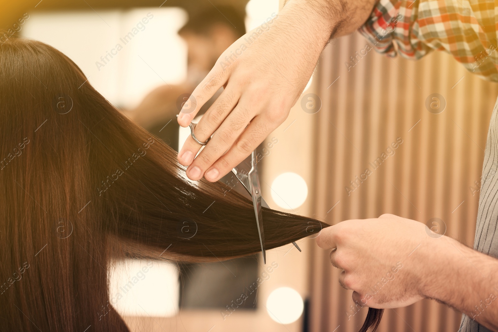 Image of Barber making stylish haircut with professional scissors in beauty salon, closeup