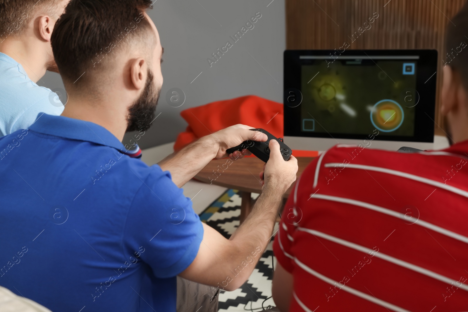 Photo of Group of friends playing video games at home