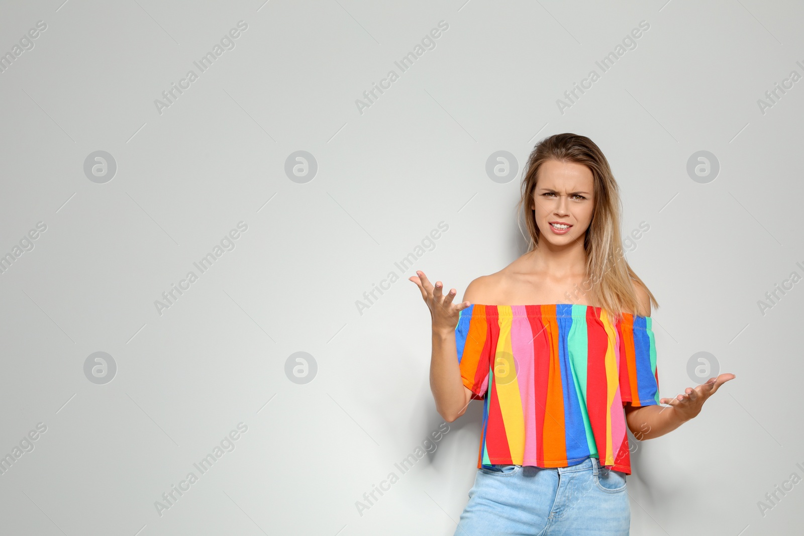 Photo of Portrait of emotional woman on light background