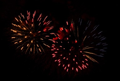 Image of Beautiful bright fireworks lighting up night sky