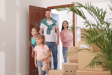 Happy family with children moving into new house