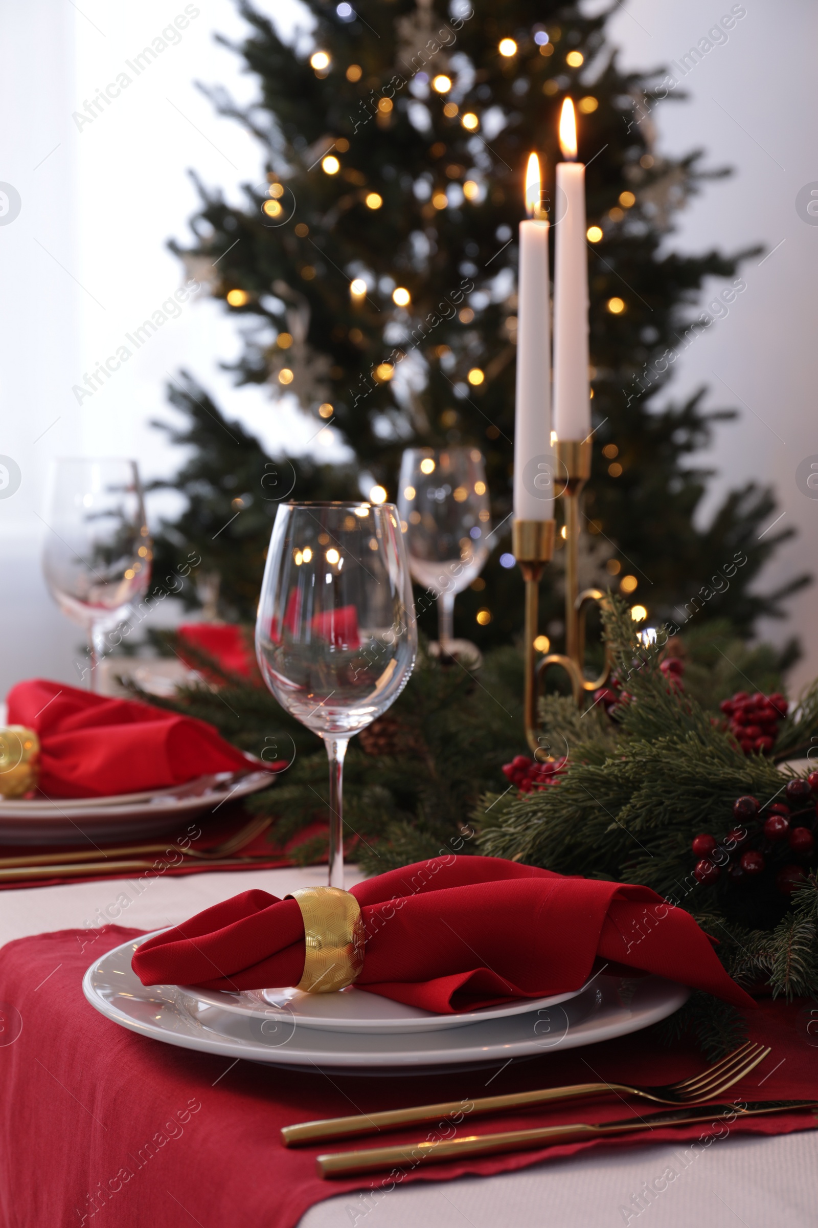 Photo of Beautiful place setting with Christmas decor on table indoors