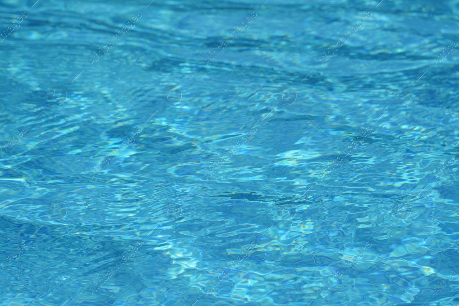 Photo of Clear refreshing water in swimming pool on sunny day, closeup