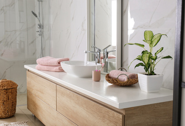 Modern mirror and vessel sink in stylish bathroom