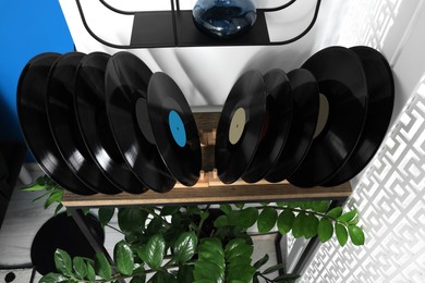 Photo of Vinyl records on wooden stand in living room