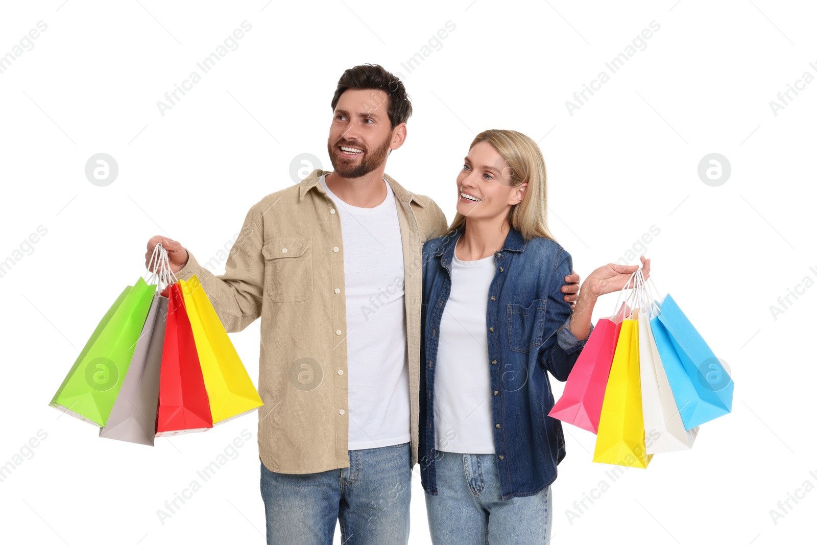 Photo of Family shopping. Happy couple with many colorful bags on white background