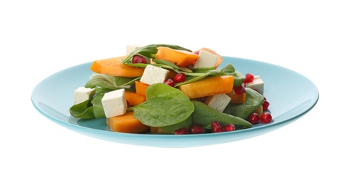 Delicious persimmon salad with pomegranate and spinach isolated on white