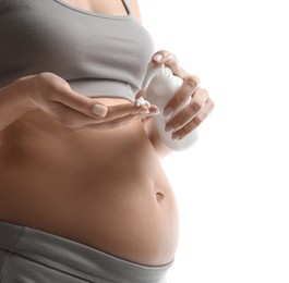 Photo of Pregnant woman with cosmetic product on white background, closeup