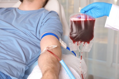 Photo of Man donating blood to save someone's life in hospital