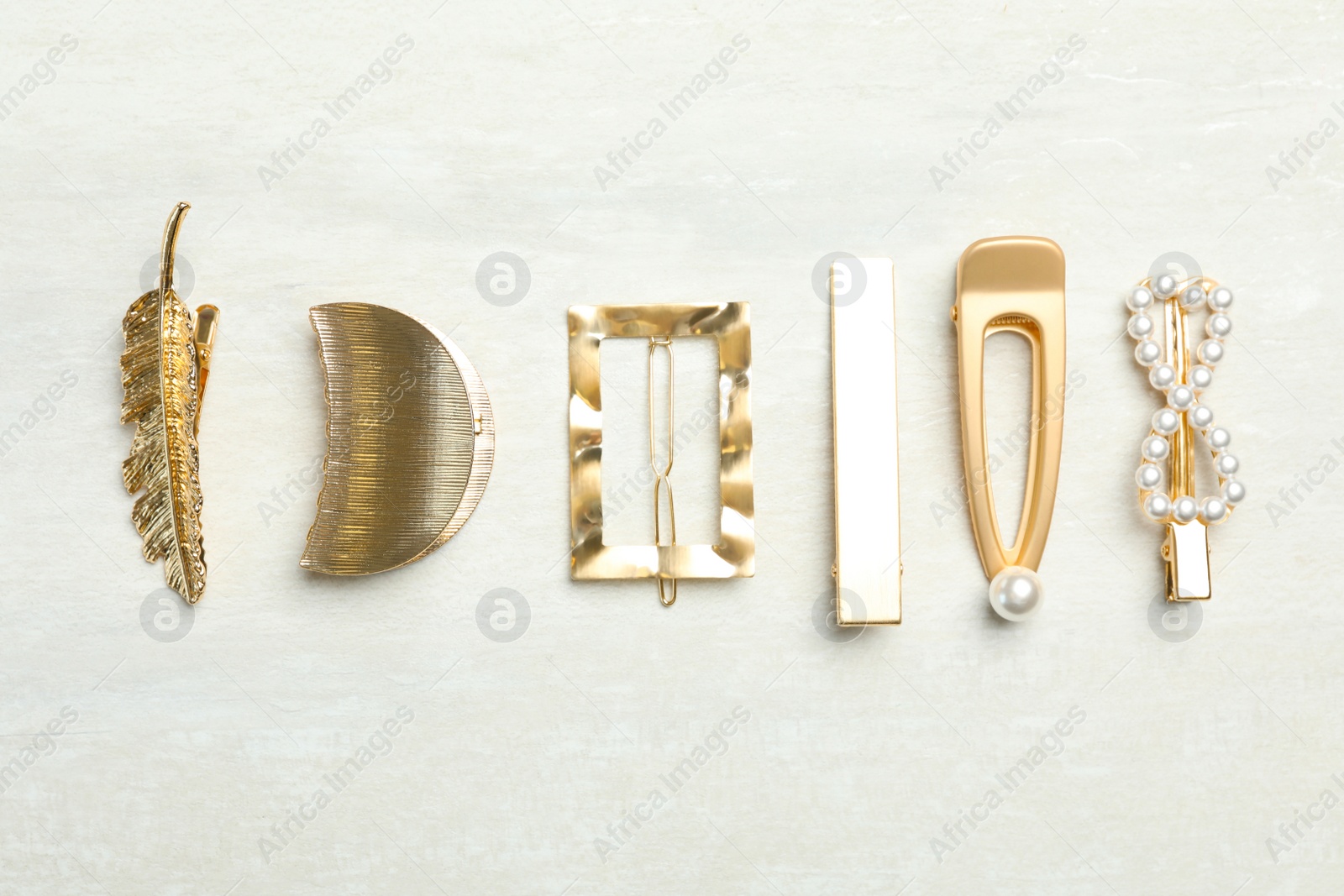 Photo of Beautiful different hair clips on white table, flat lay