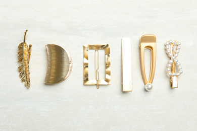 Photo of Beautiful different hair clips on white table, flat lay