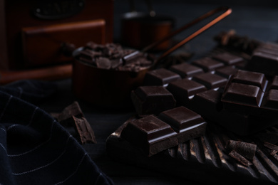 Tasty dark chocolate on black table, closeup