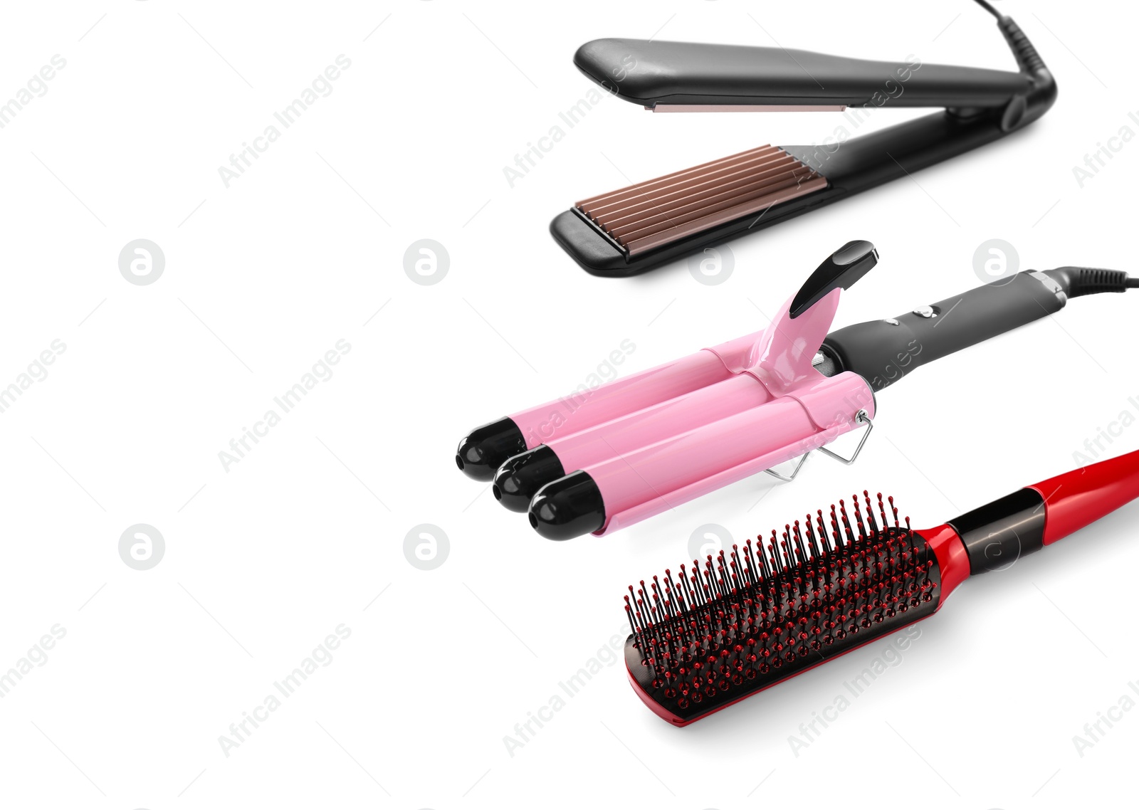 Image of Hair irons and brush on white background