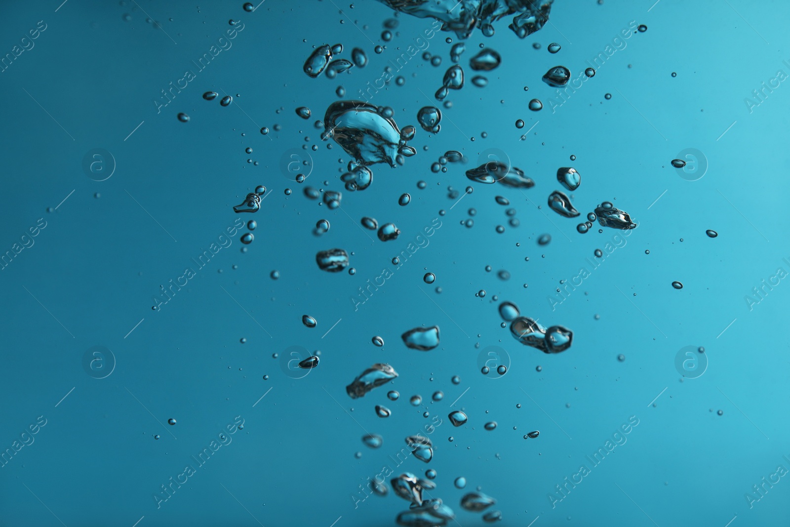 Photo of Air bubbles in water on blue background