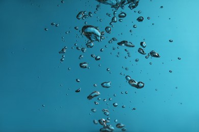 Photo of Air bubbles in water on blue background