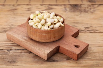 Photo of Sprouted kidney beans on wooden table, closeup