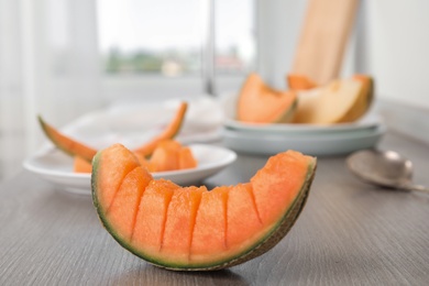 Slice of ripe cantaloupe melon on wooden table