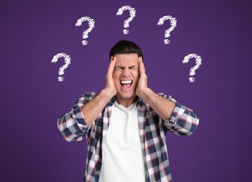 Image of Amnesia. Stressed man and question marks on purple background