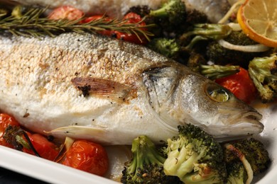 Photo of Delicious fish with vegetables in baking dish, closeup