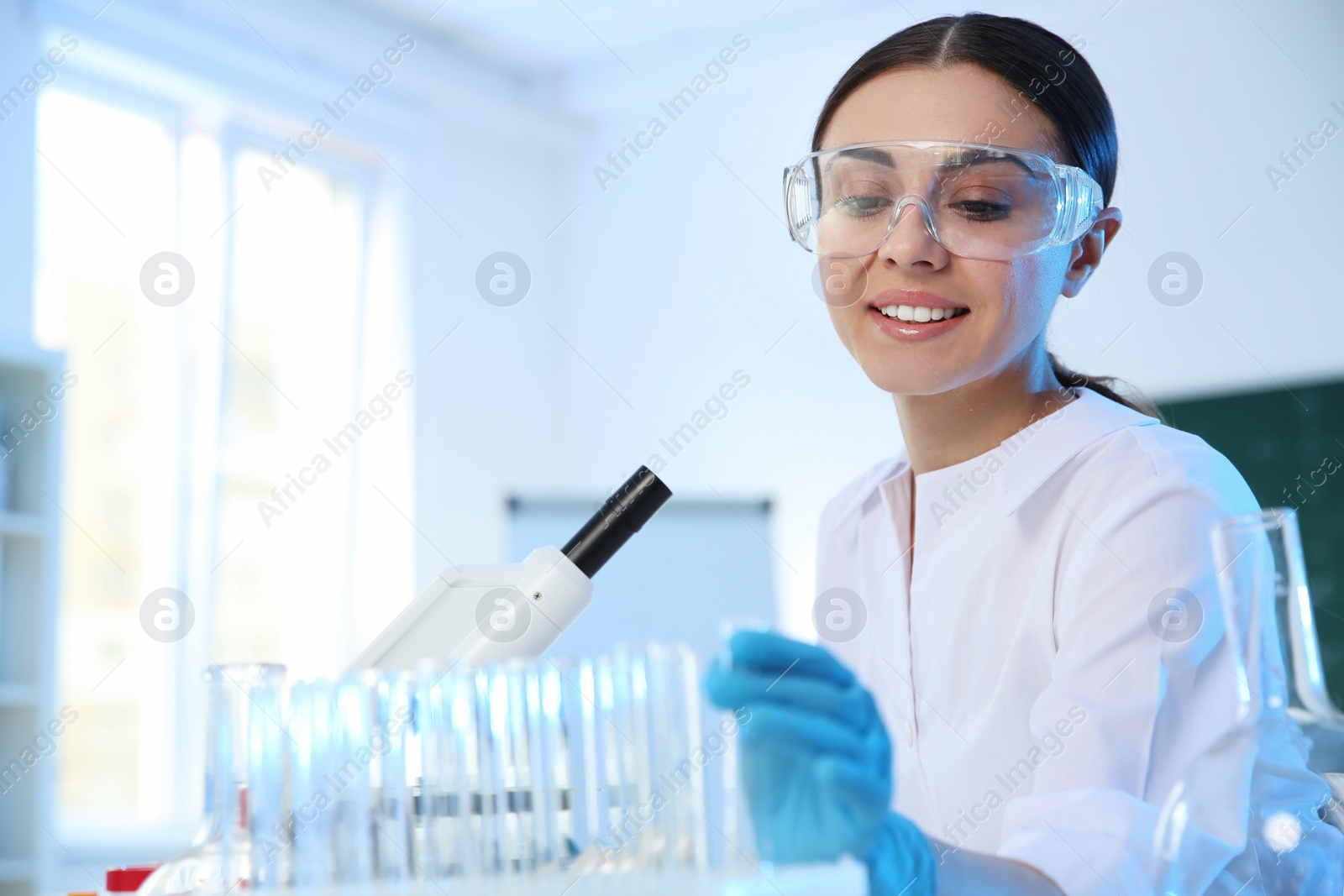 Photo of Female scientist working in chemistry laboratory, space for text