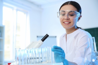 Female scientist working in chemistry laboratory, space for text